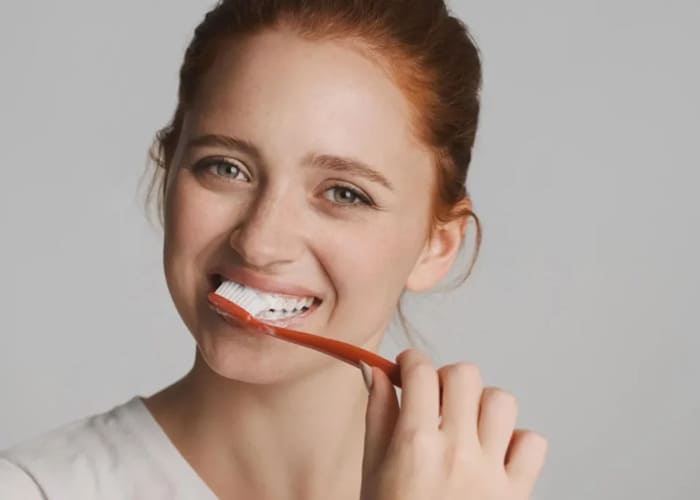 a woman brushing teeth